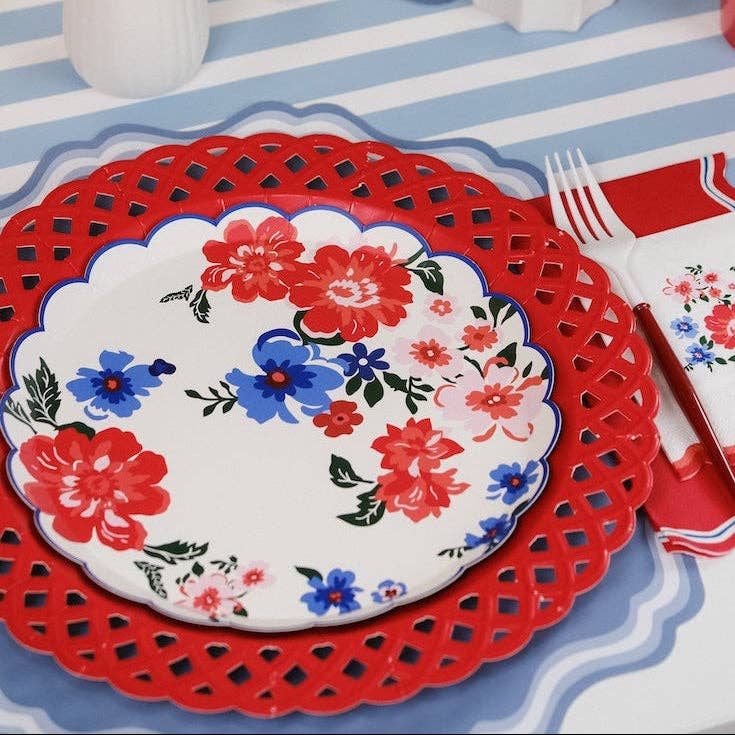 Overhead view of a curated Red White and Blue Tableware spread with floral and striped accents.