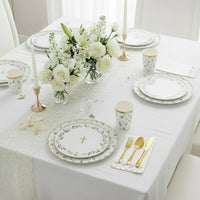 eucalyptus communion table with plates cups and greenery
