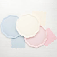 Pastel flatlay showing cream, sky blue, and pink compostable dinner plates.