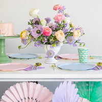 Spring party table with flowers and mixed pastel compostable plates including sky blue.