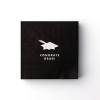 Black cocktail napkin with white graduation cap icon and “Congrats Grad” text
