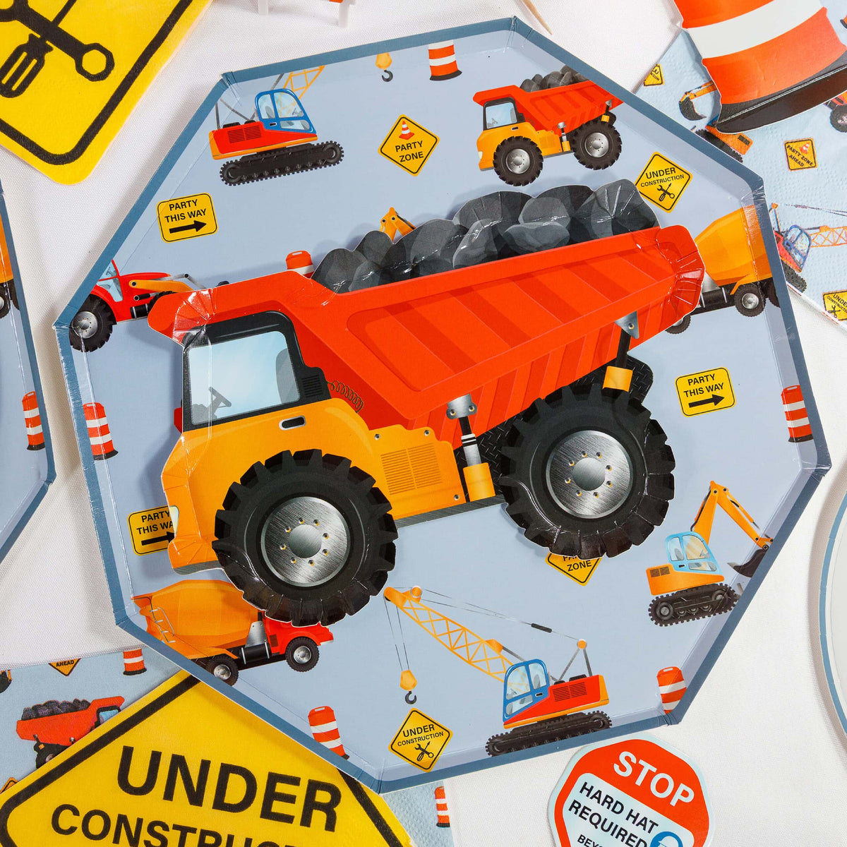 construction plate with dump truck and under construction signs