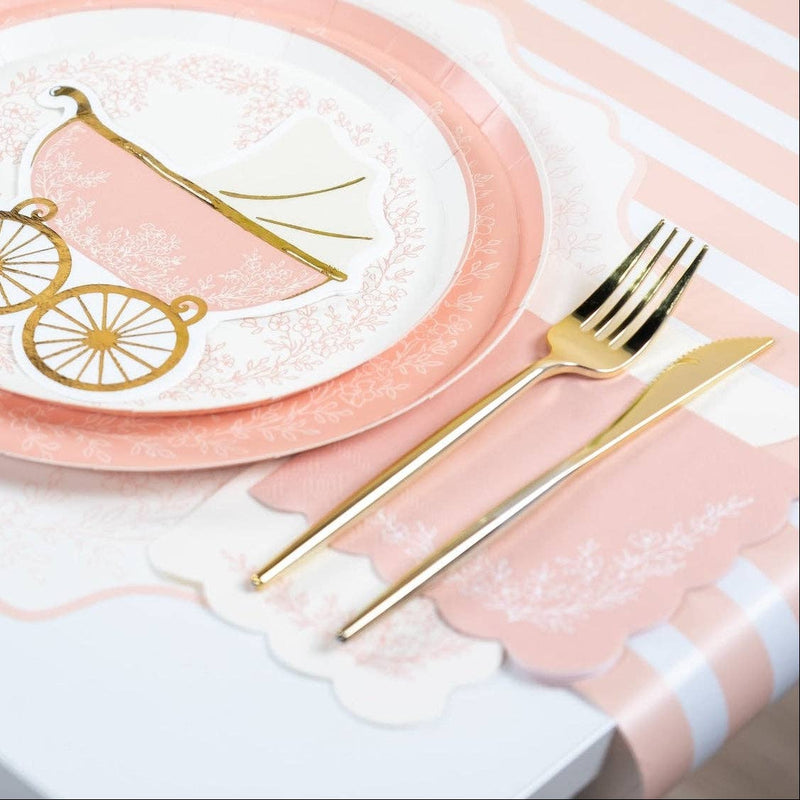 Pink floral guest towel styled under gold cutlery on a striped tablecloth