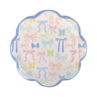 stack of bow patterned party plates in pastel colors.