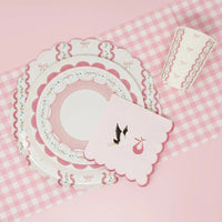 Lace dessert plate and stork napkin on a pink gingham runner