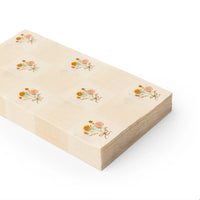 Angled stack of folded guest towels showing the check pattern and floral sprigs.