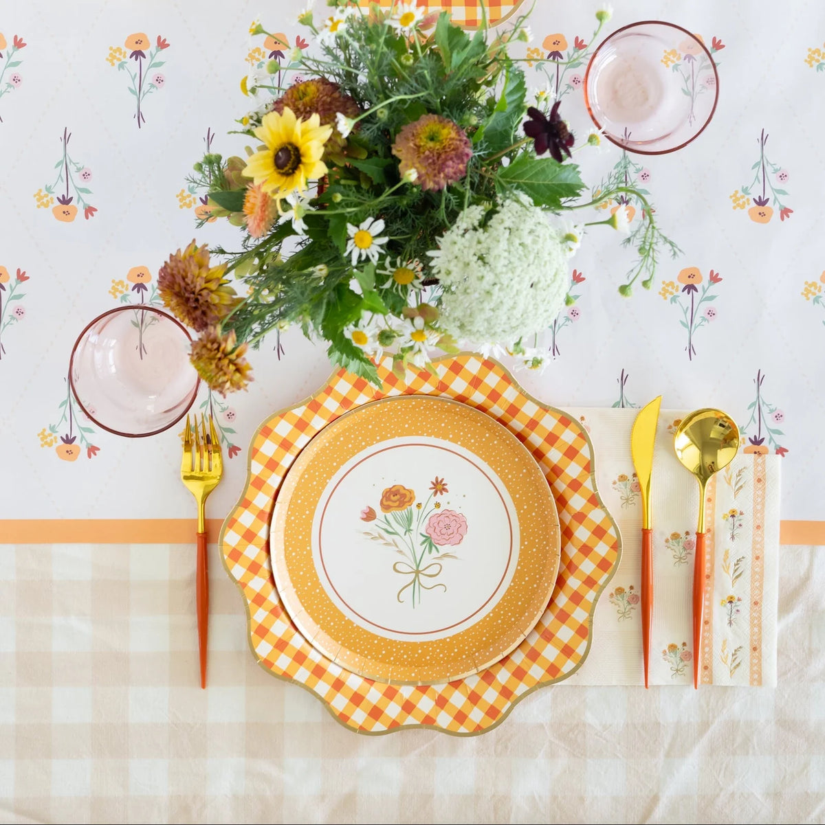 Side angle of the floral paper runner highlighting the warm colors and scalloped plates on top.