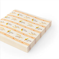 Angled stack of 6.5-inch floral lunch napkins showing gold-foil details along the stripes.