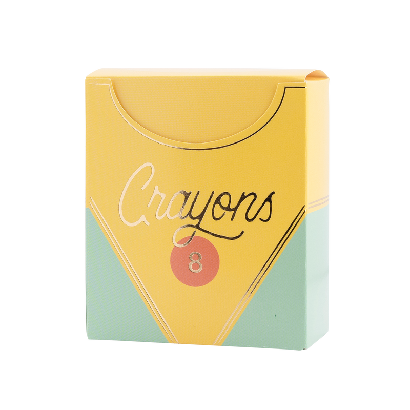 Single assembled closed crayon box-shaped treat box on white background. Fully constructed yellow and mint green box with flip-top lid open slightly. Gold foil "Crayons" script, orange circle badge with "8," silver/gold foil accent lines visible.