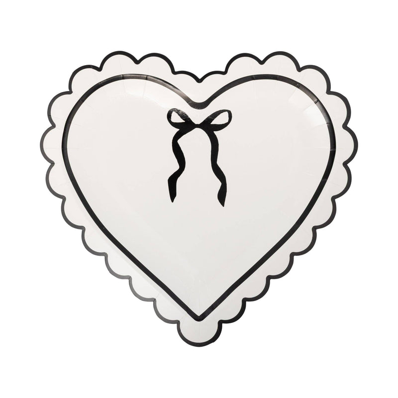 Cream heart-shaped paper plate with black scalloped border and bow design.