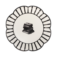 Decorative paper plate featuring a black-and-white striped border with a stack of spell books at the center.