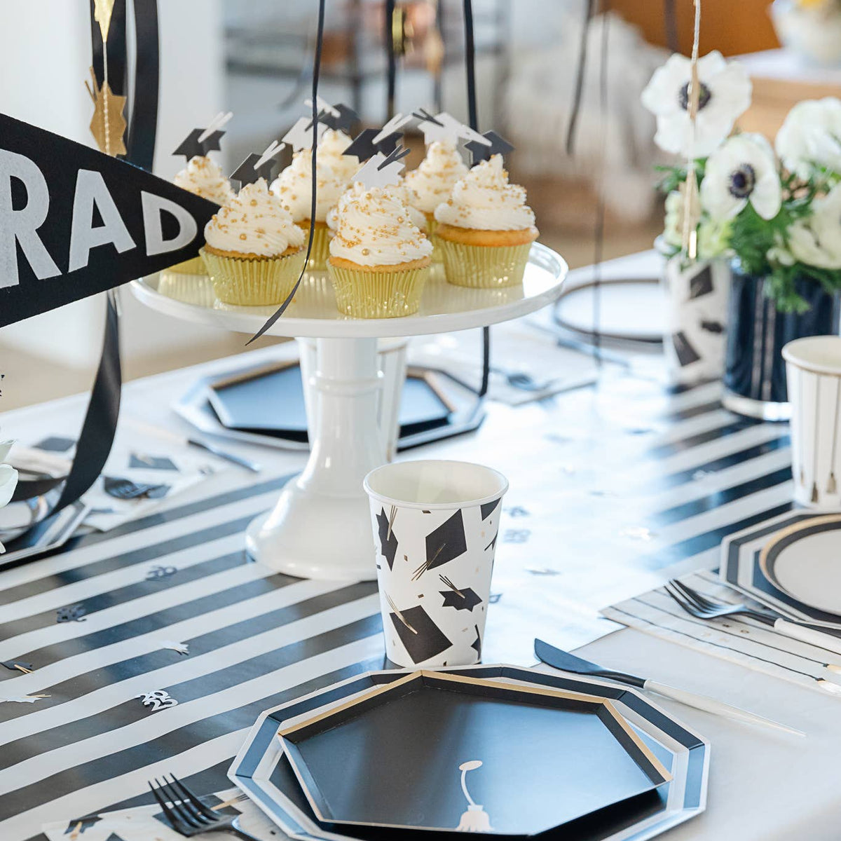 Cupcake display with hanging graduation hat garland
