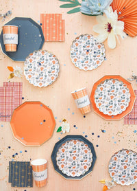 Fall table styling: Navy premium plates styled with floral dessert plates, orange plates, confetti, and plaid cups.