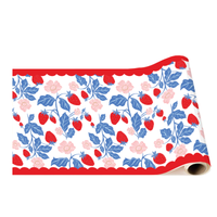 A roll of decorative table runner paper featuring a repeating pattern of red strawberries, blue leaves, and pink flowers bordered by a red scalloped edge.