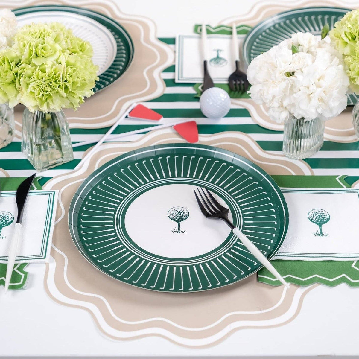 Styled golf party table with striped runner, plates, and napkins