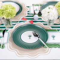 Styled golf party table with striped runner, plates, and napkins