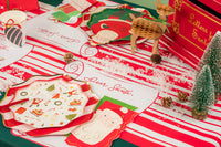 Overhead spread with multiple settings using red striped runners and scroll Christmas placemats.