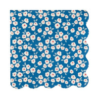 Single deep blue daisy floral paper cocktail napkin flat lay showing white flowers with red centers and scalloped edge