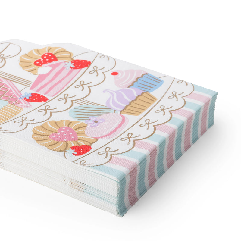 Stack of the die-cut dessert-tower napkins showing the tiered patisserie shape and pastel design from an angle.