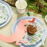 Close-up of dinosaur plate with cupcake and party napkin.