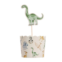 Dinosaur cupcake with topper pick inserted into liner
