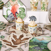 Dinosaur footprint napkins styled on party table with cupcake and decor
