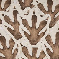 Stack of dinosaur footprint napkins layered together
