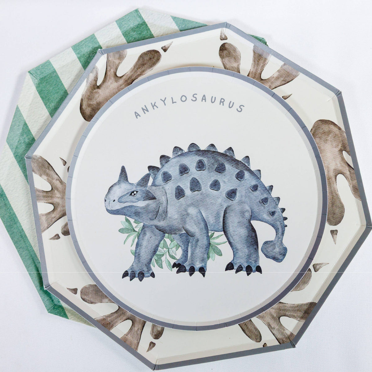Dinosaur footprint plate layered with ankylosaurus plate and green plate
