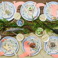 Dinosaur party table setup with themed plates and decorations.