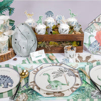 Dinosaur party table setup with placemats and themed decor
