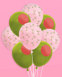 Bouquet of pink martini and green olive latex balloons arranged on pink background showing full mix of both designs