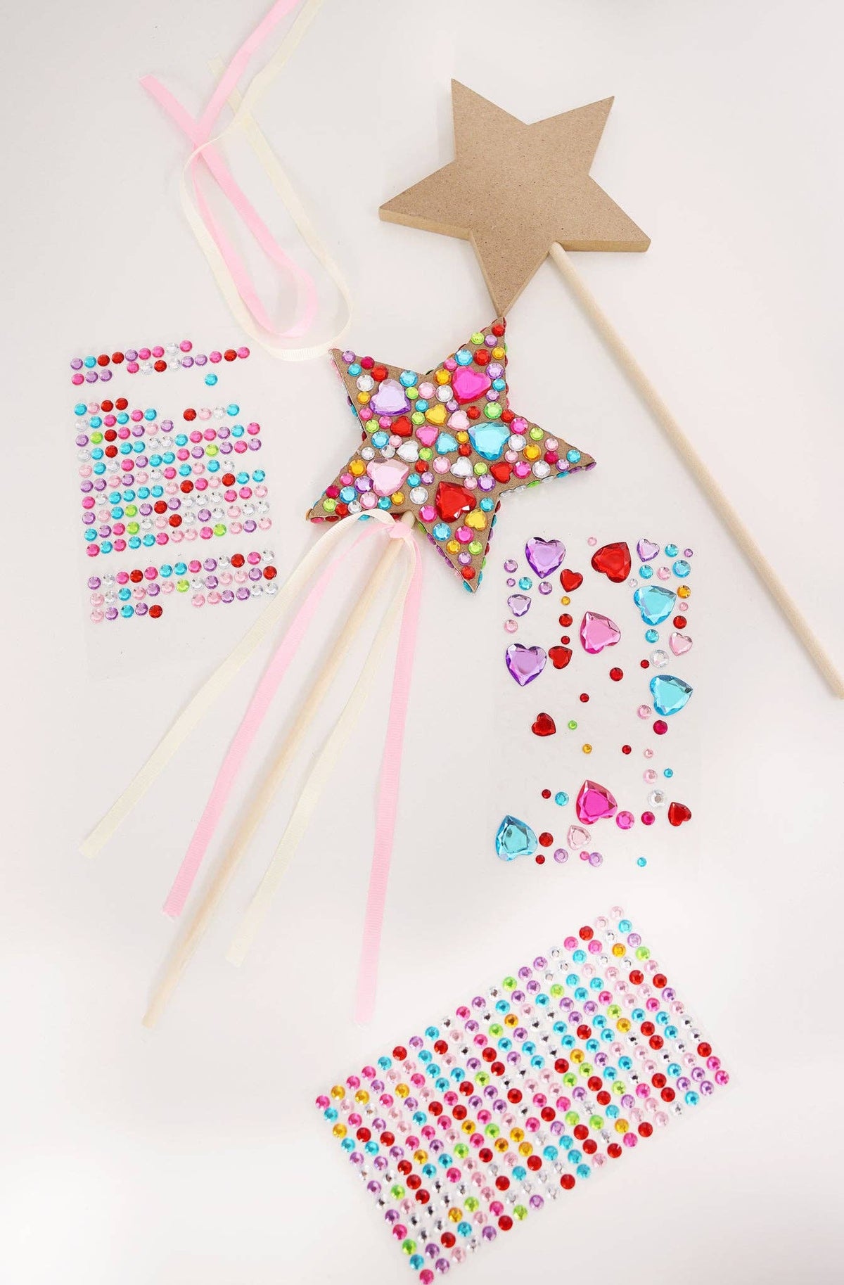 The contents of the Princess Wand Kit including wooden wands, ribbon tails, and colorful gem sticker sheets.