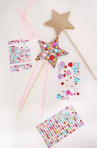 The contents of the Princess Wand Kit including wooden wands, ribbon tails, and colorful gem sticker sheets.