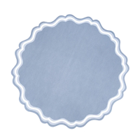 Single dusty blue round scalloped paper placemat on white background, straight-on view. Full silhouette shows the large-scale scalloped edge (approximately 20–22 scallop points) and the two concentric wave border lines in white and light blue against the slate blue body.