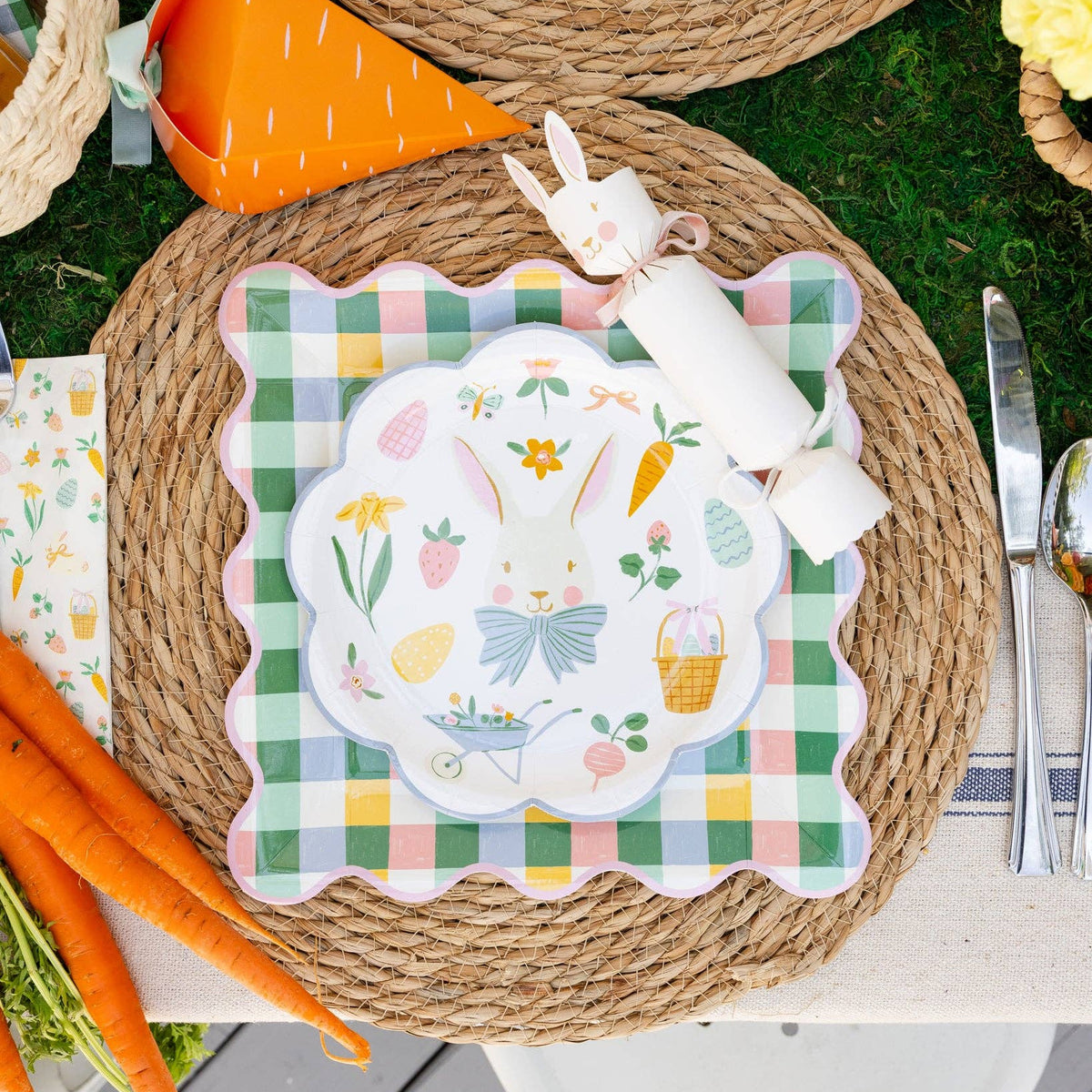 Bunny cracker styled beside Easter tableware with carrots and spring elements
