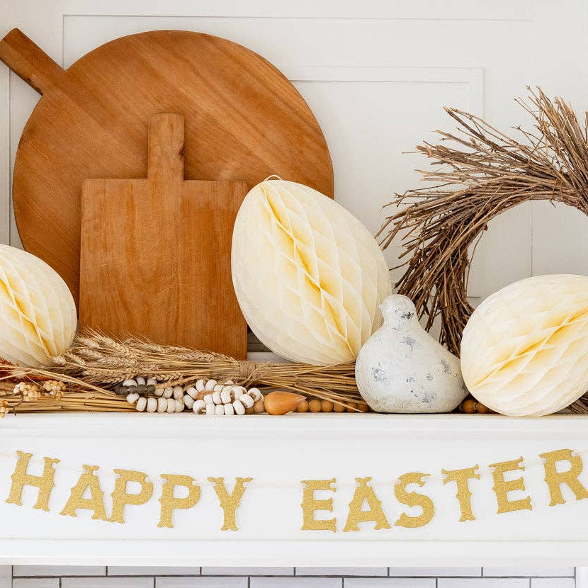 Neutral Easter mantel decorated with honeycomb eggs and gold Happy Easter banner.