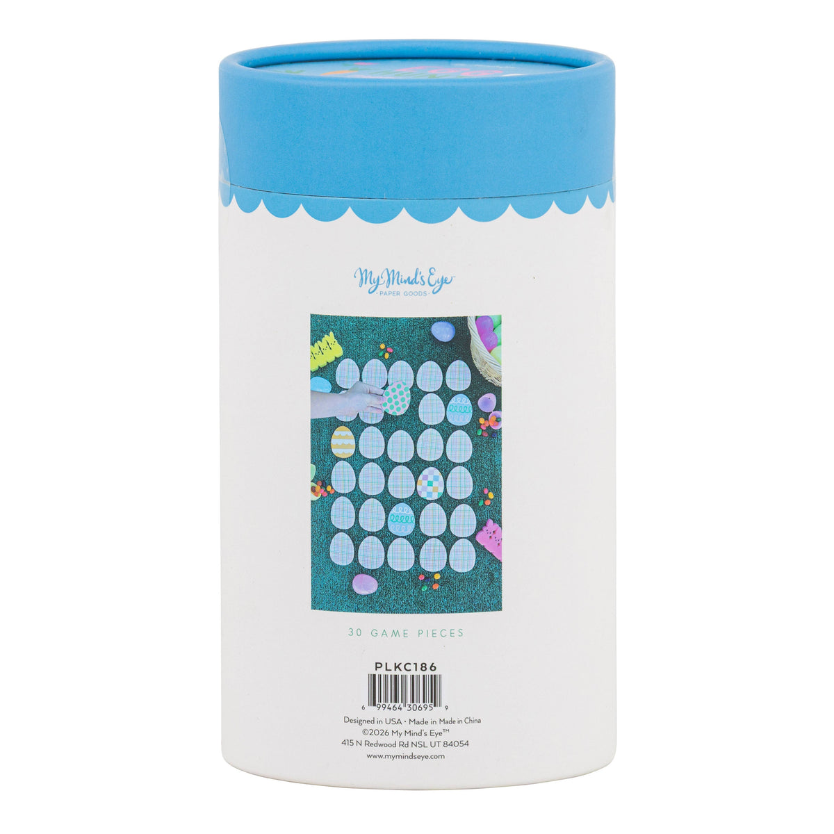 Back view of the storage tube for the Easter egg hunt memory match game showing a lifestyle photo of the game pieces being played on grass.