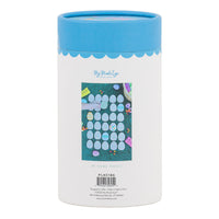 Back view of the storage tube for the Easter egg hunt memory match game showing a lifestyle photo of the game pieces being played on grass.