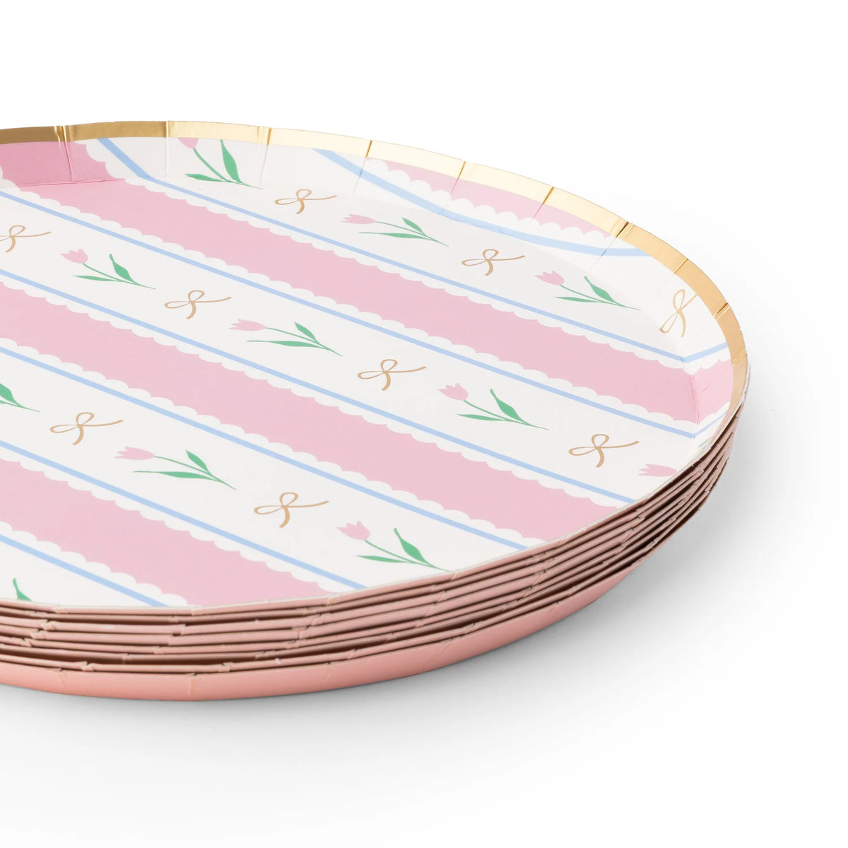 Angled stack of pink striped Easter paper plates with tulip and gold bow print and gold foil rim on white background