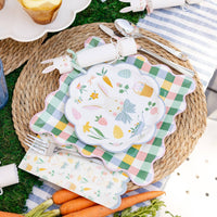 Easter tablescape with bunny plates, gingham chargers, and Easter pattern napkins