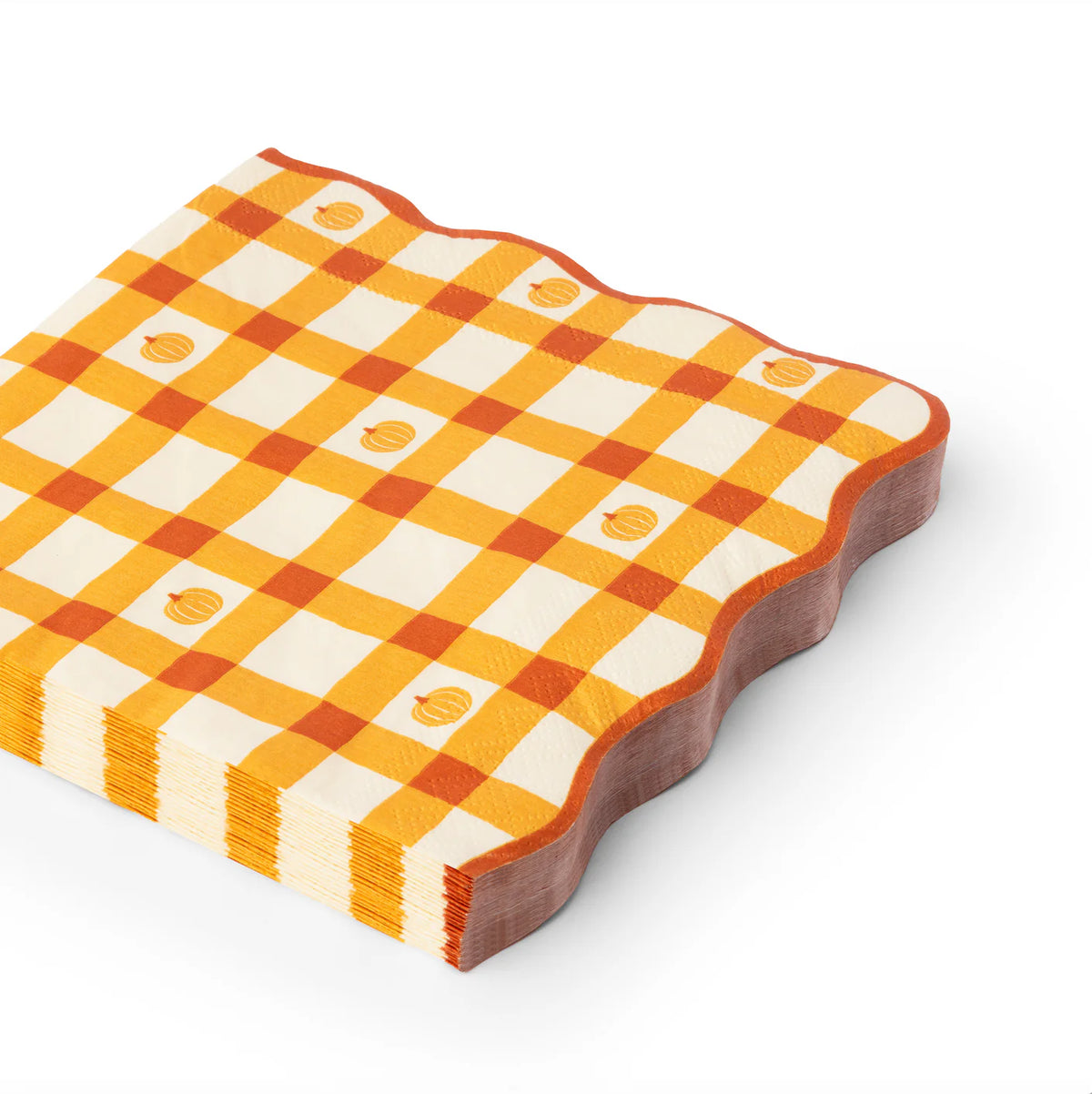 Angled stack of scalloped large paper napkins in orange gingham with tiny pumpkin icons.