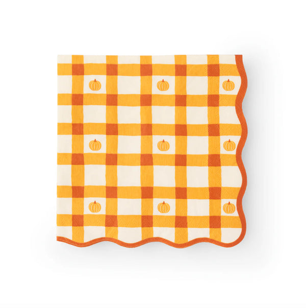 Single folded napkin showing orange plaid pattern with pumpkins and wavy border, front view.