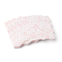 Angled stack of scalloped pink floral lunch napkins highlighting 3‑ply thickness and foil speckles.