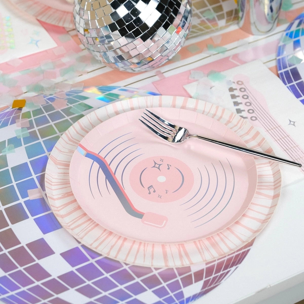 Detailed shot of a vinyl record plate centered on a 14-inch holographic disco ball charger.
