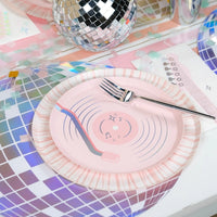 Detailed shot of a vinyl record plate centered on a 14-inch holographic disco ball charger.
