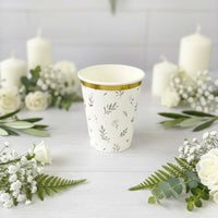 eucalyptus floral paper cup with candles and flowers background
