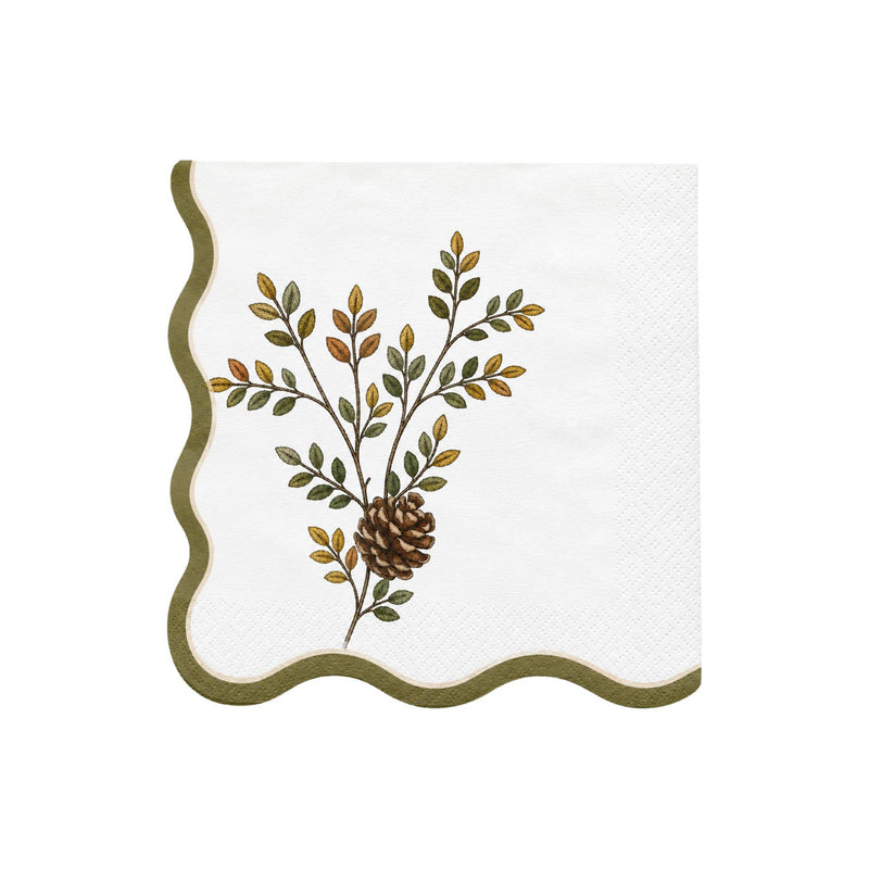 Cream cocktail napkin with a green wavy scalloped edge and an evergreen sprig with a pinecone.