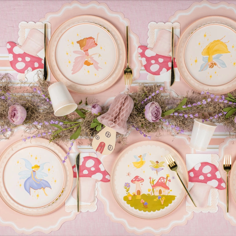 Overhead tablescape pairing small plates with dinner plates and mushroom napkins.