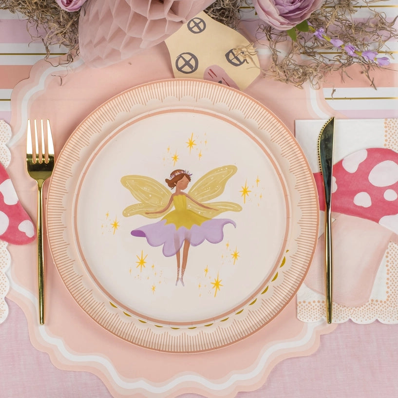 Place setting with yellow-wing fairy layered over scalloped charger.