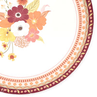 Close-up of the fall dessert plate border showing the intricate burgundy-and-gold pattern detail with part of the floral bouquet.